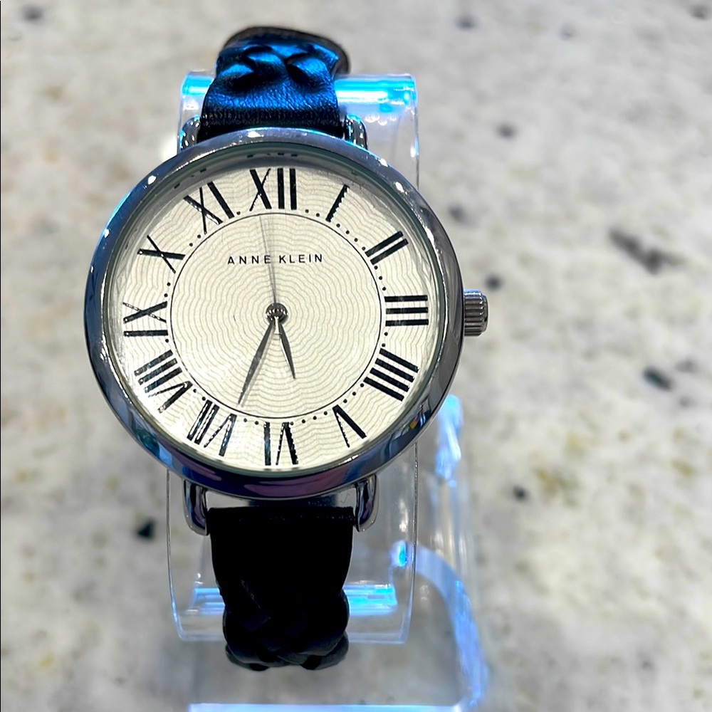 Anne Klein quartz watch with large white dial and black Roman numerals.